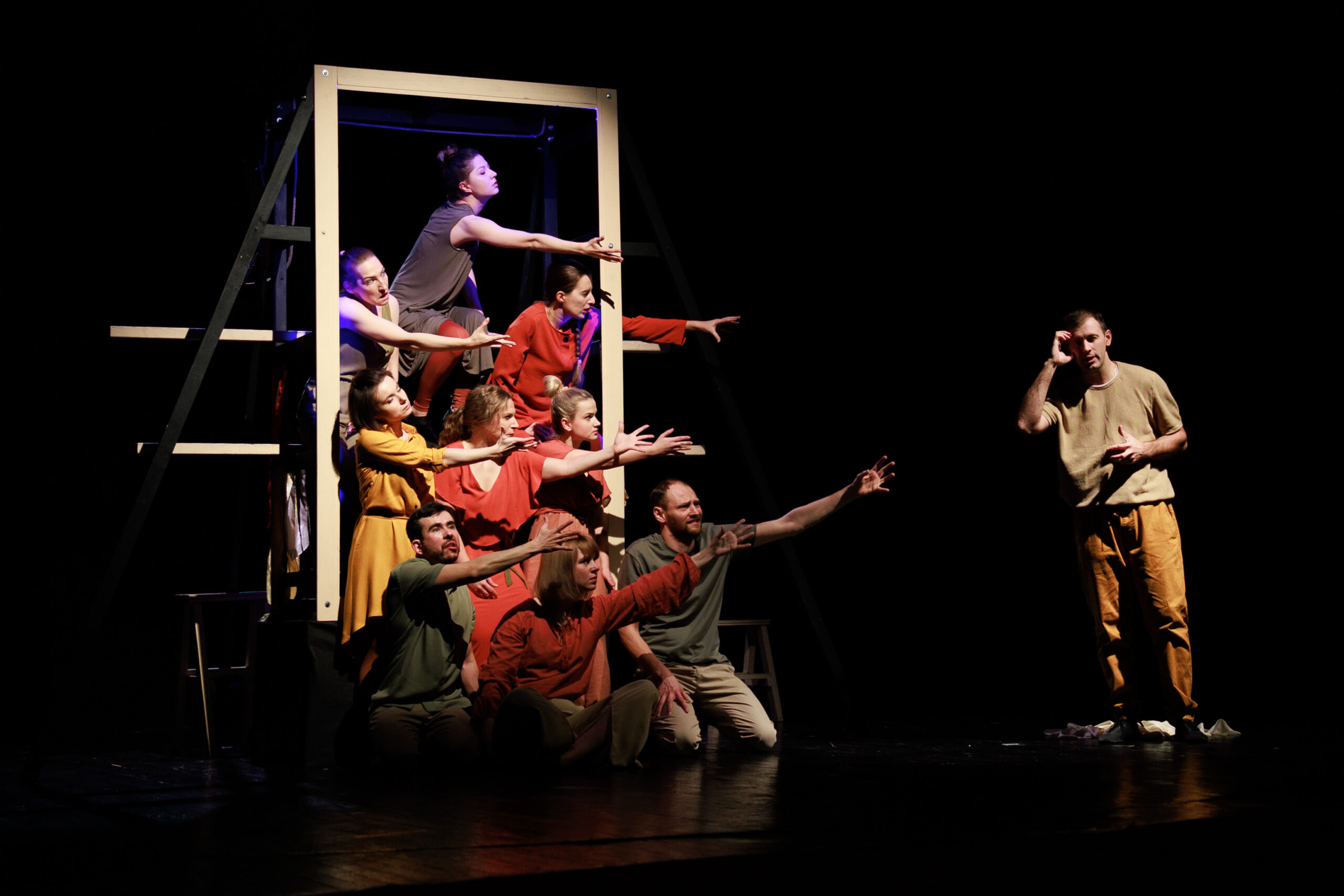 Actors and actresses perform a modern performance on the stage of the theater.