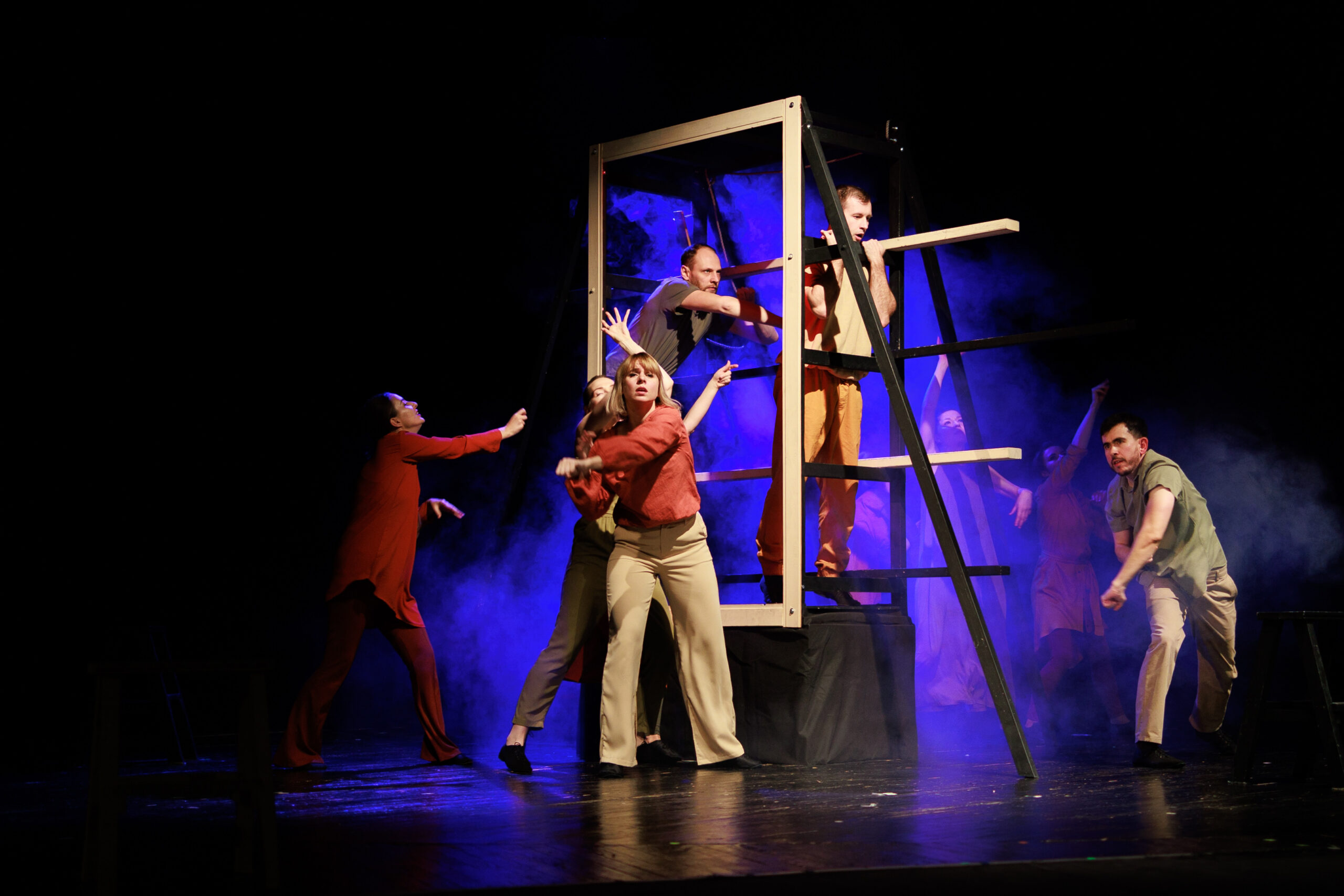 Actors and actresses perform a modern performance on the stage o